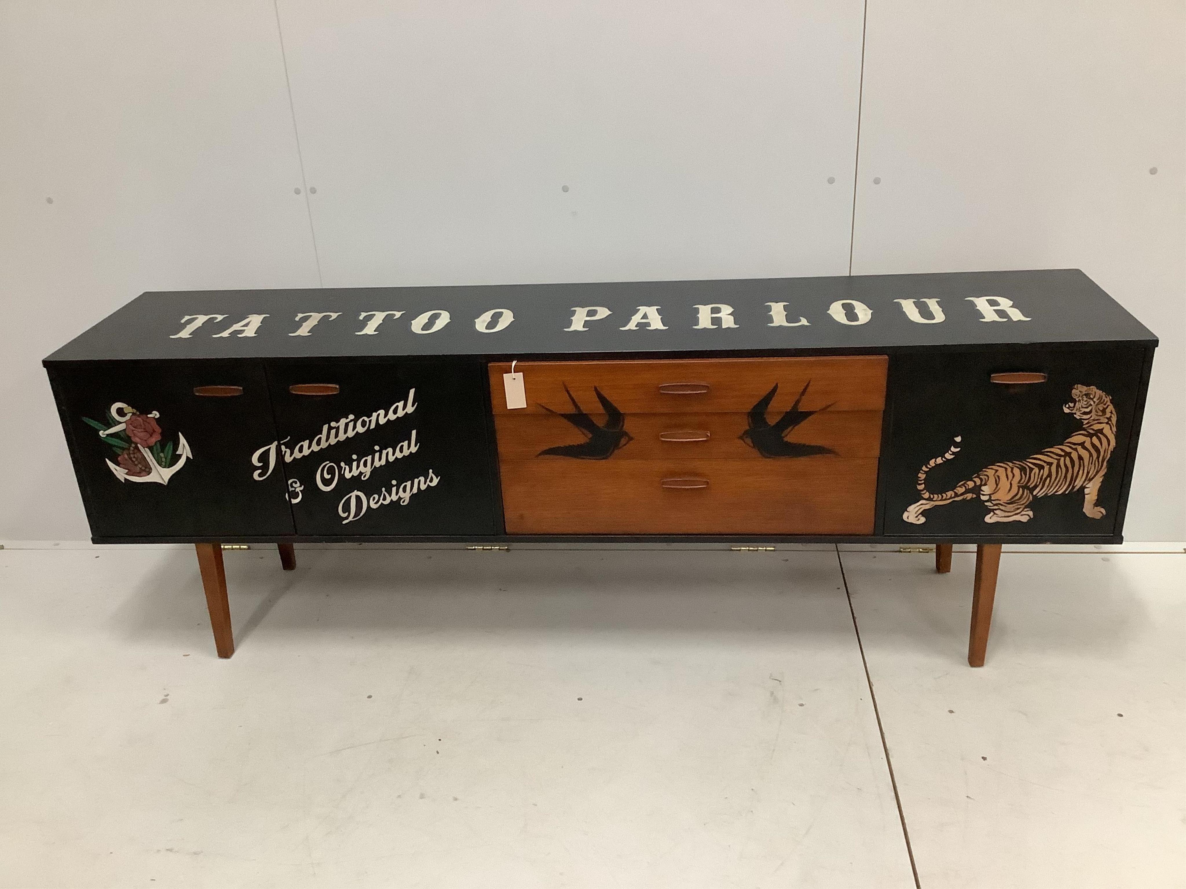 A decorative mid century teak sideboard, later painted, width 203cm, depth 43cm, height 71cm. Condition - good